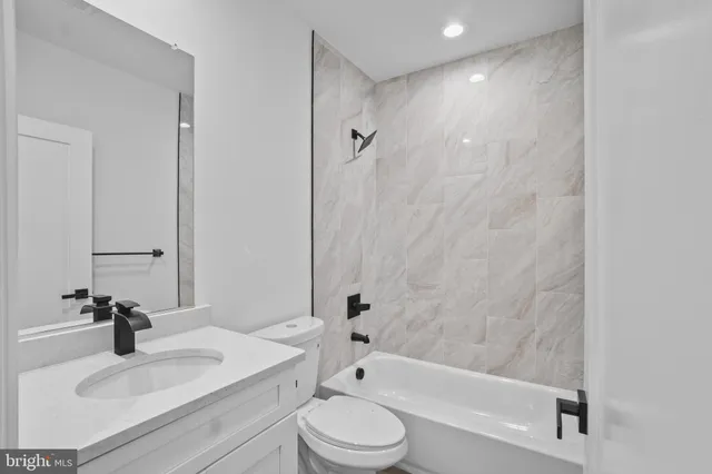 a bathroom with a sink a toilet and a bathtub