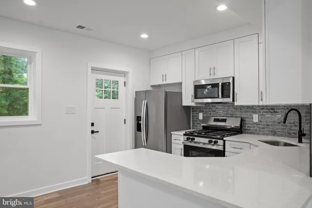 a kitchen with stainless steel appliances a refrigerator and a sink