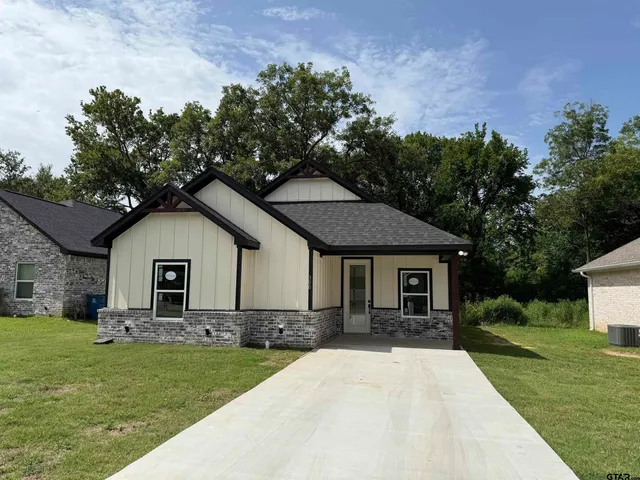 a front view of house with yard and green space