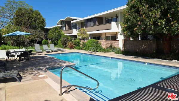a swimming pool with outdoor seating and yard