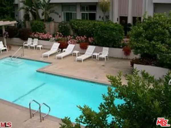 a view of a backyard with sitting area
