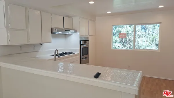 a kitchen with a sink stainless steel appliances and cabinets