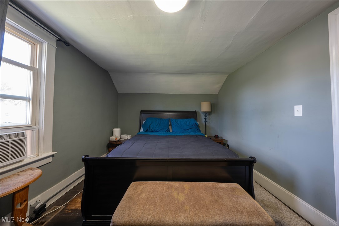 1709 Elm Road Northeast Warren, OH 44483 - Photo 14 of 21 Carpeted bedroom featuring cooling unit and vaulted ceiling