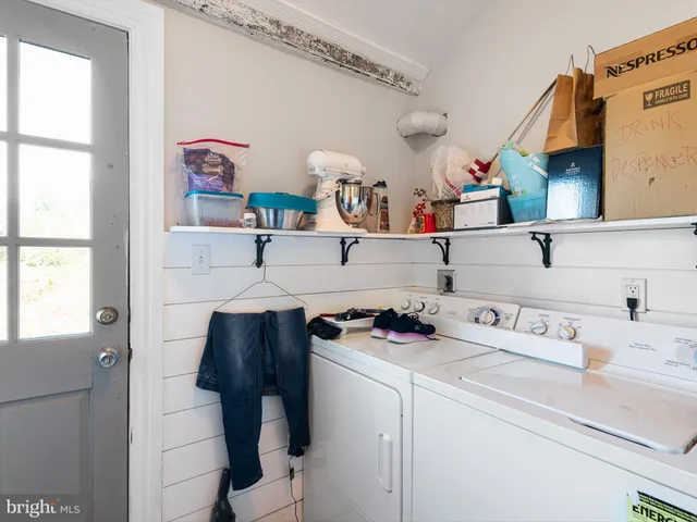 a utility room with closet dryer and washer
