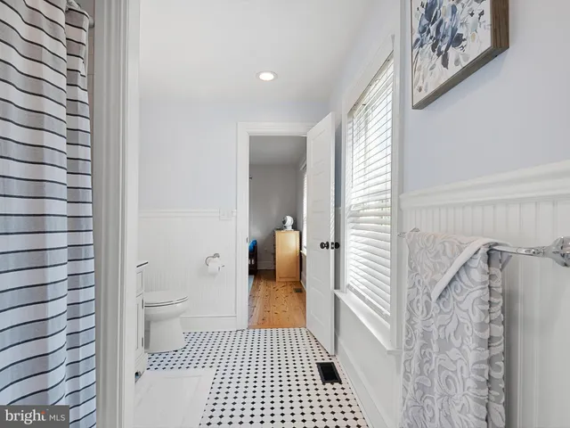 a bathroom with a toilet a sink and a shower
