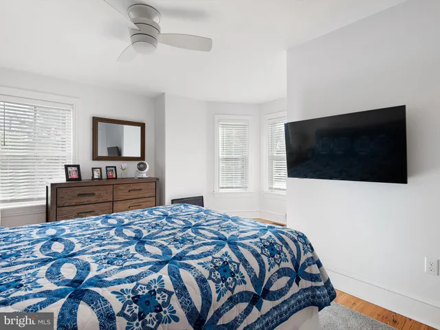 a bedroom with a bed and a television