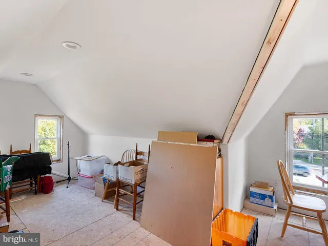 a living room with furniture a air conditioner vent and a window