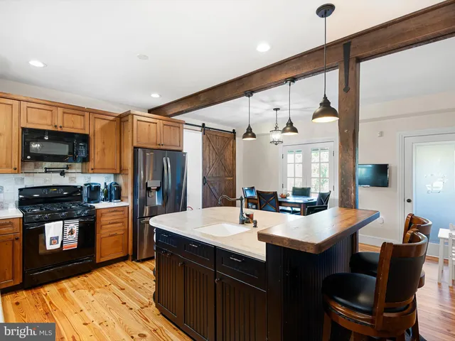 a kitchen with stainless steel appliances a sink stove and refrigerator