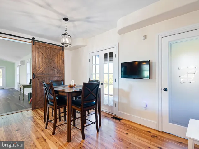 a view of a livingroom with furniture window and wooden floor