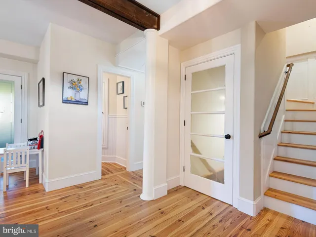 a view of a hallway with wooden floor and entryway