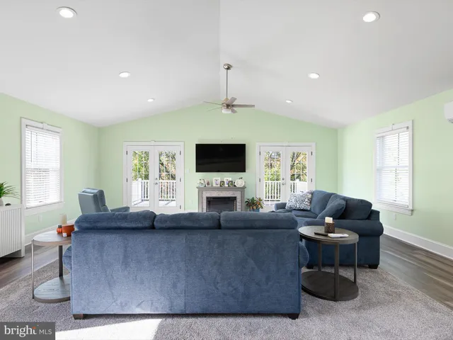 a living room with furniture flat screen tv and a window
