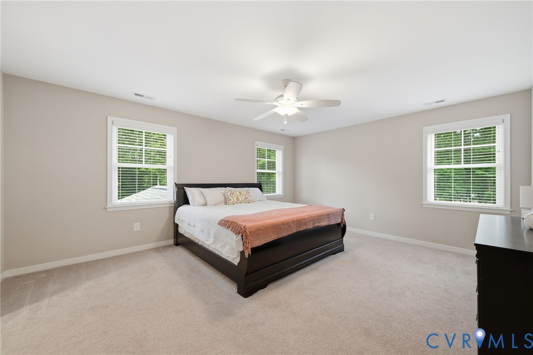 7598 Rural Point Road Mechanicsville, VA 23116 - Photo 22 of 41 a spacious bedroom with a bed and a flat screen tv