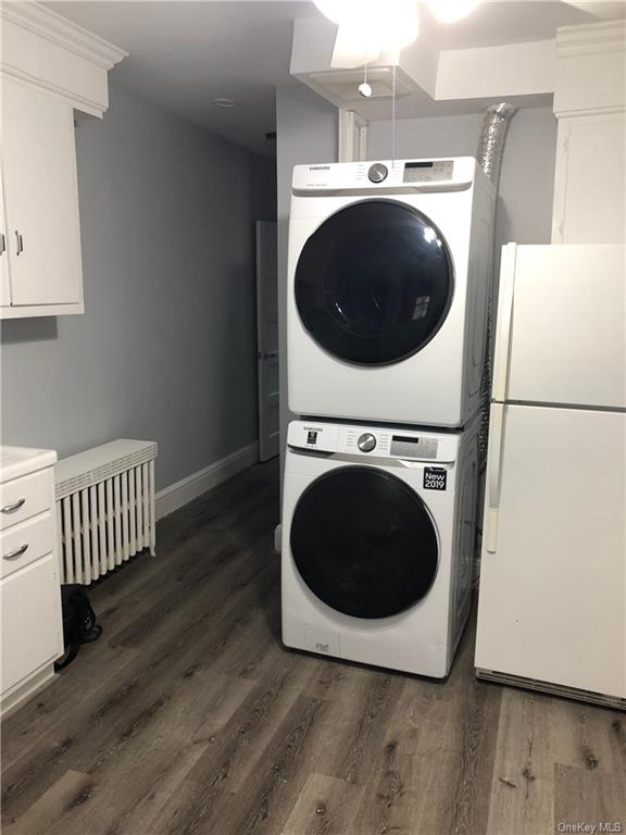 a room with wooden floor and washing machine