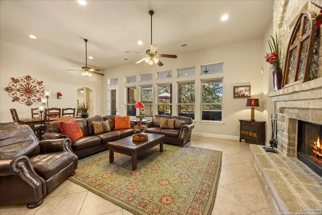 a living room with furniture fireplace and a chandelier