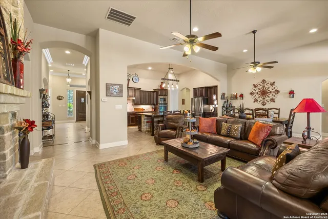 a living room with furniture a dining table and chairs