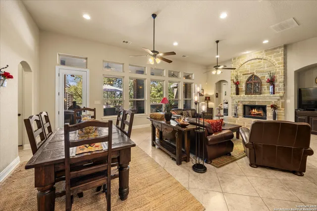 a living room with furniture kitchen view and a chandelier