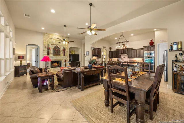 a living room with lots of furniture and kitchen view