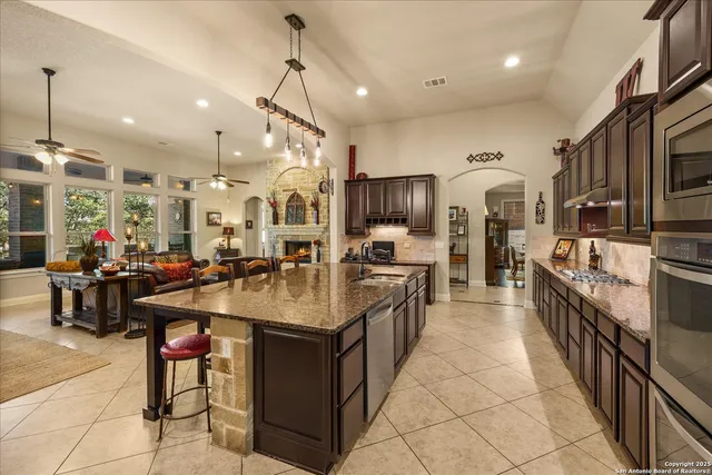 a large kitchen with lots of counter space and stainless steel appliances