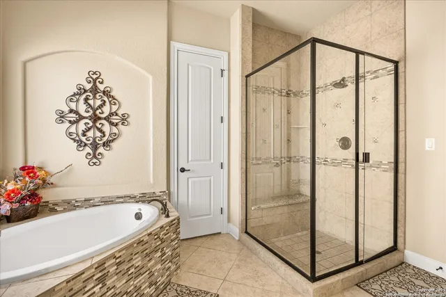 a bathroom with a bathtub and shower