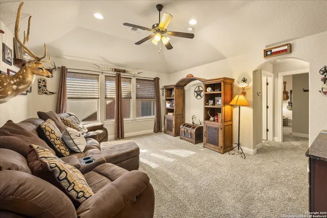 a living room with furniture ceiling fan and a rug