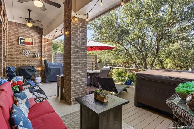 a view of a patio with a table and chairs under an umbrella