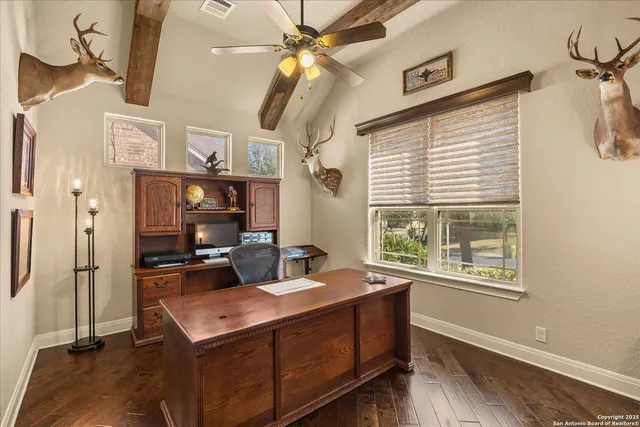 a living room with stainless steel appliances kitchen island furniture and a window