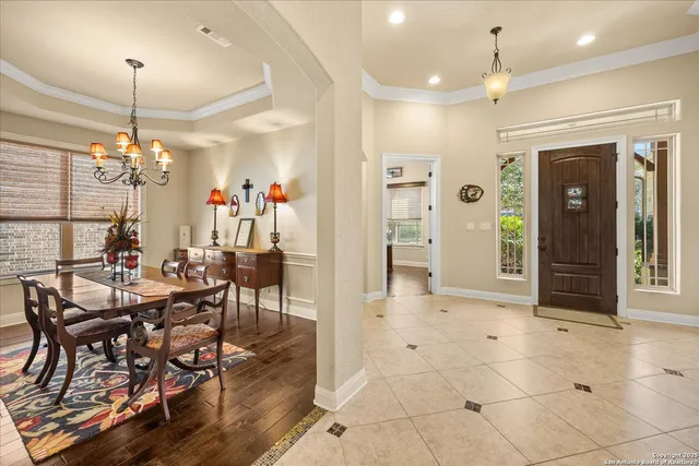 a view of a dining room with furniture and chandelier