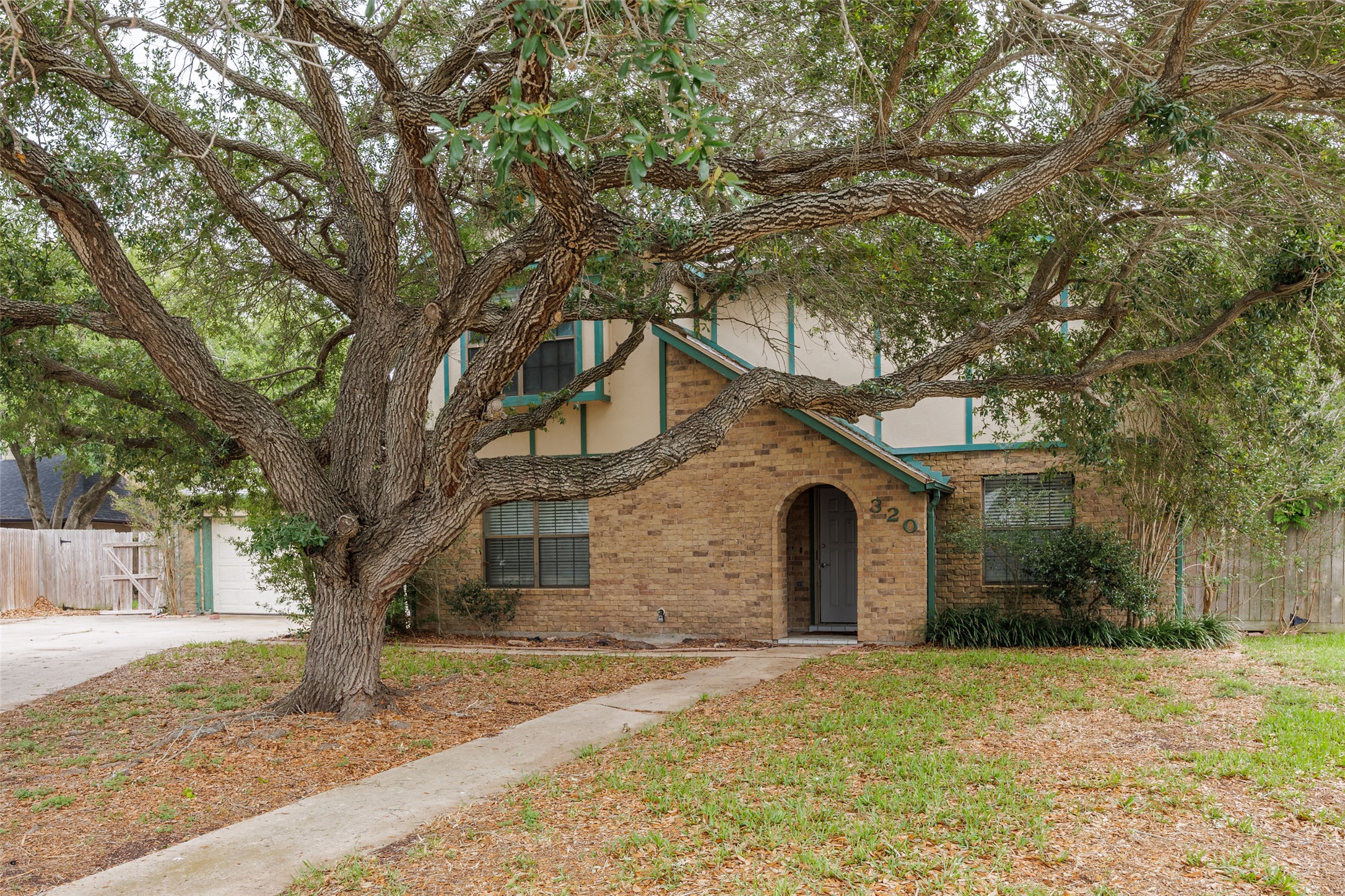 Arrive at this stately two-story residence, framed by a massive, mature oak tree and a wide, oversized driveway that provides plenty of space for guests and multiple vehicles. It is an inviting opportunity to secure a substantial home with established character and bring your own vision to life.