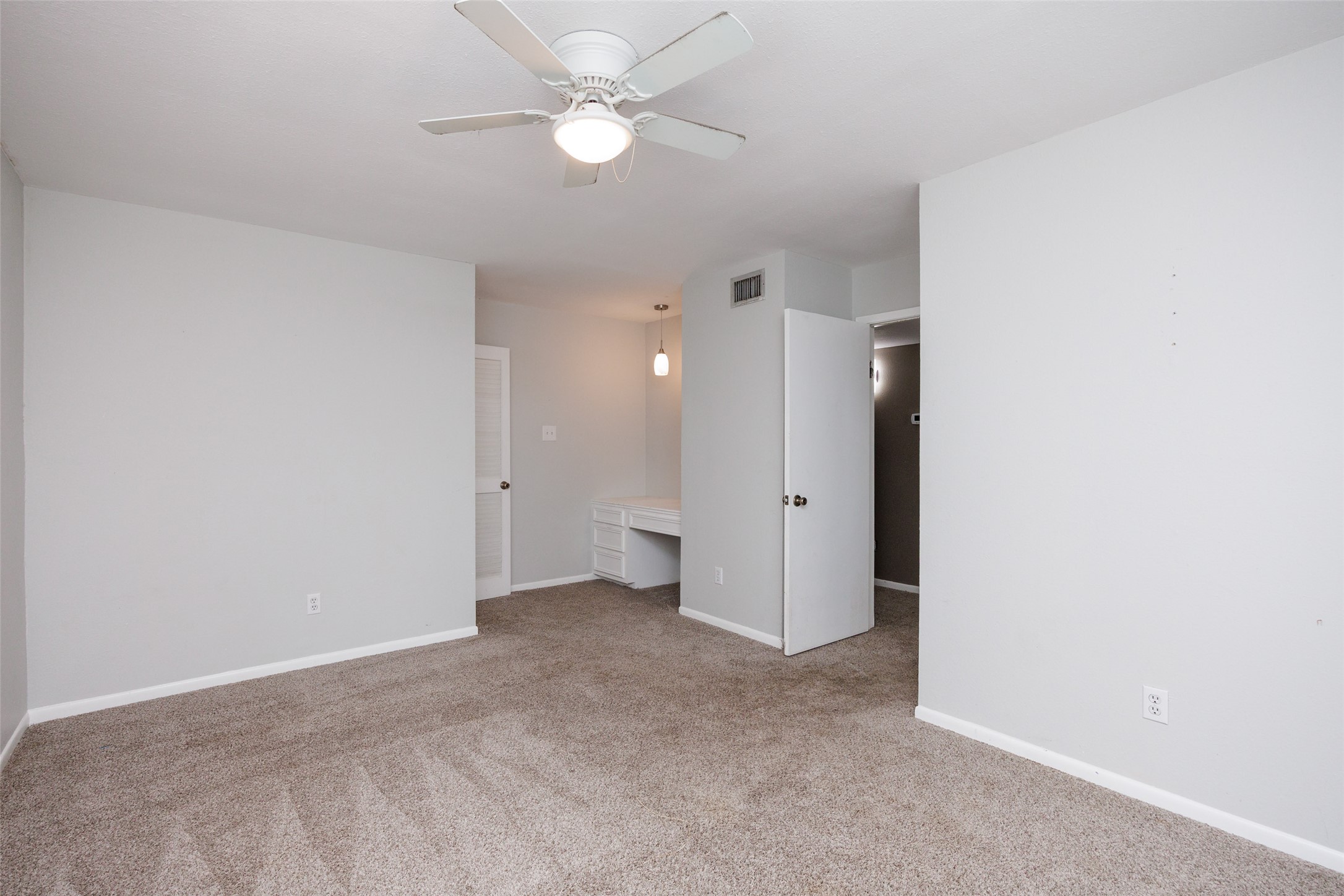 320 Long Point Drive Portland, TX 78374 - Photo 17 of 40 Spacious room featuring neutral carpeting, light gray wall paint, and a ceiling fan with integrated lighting