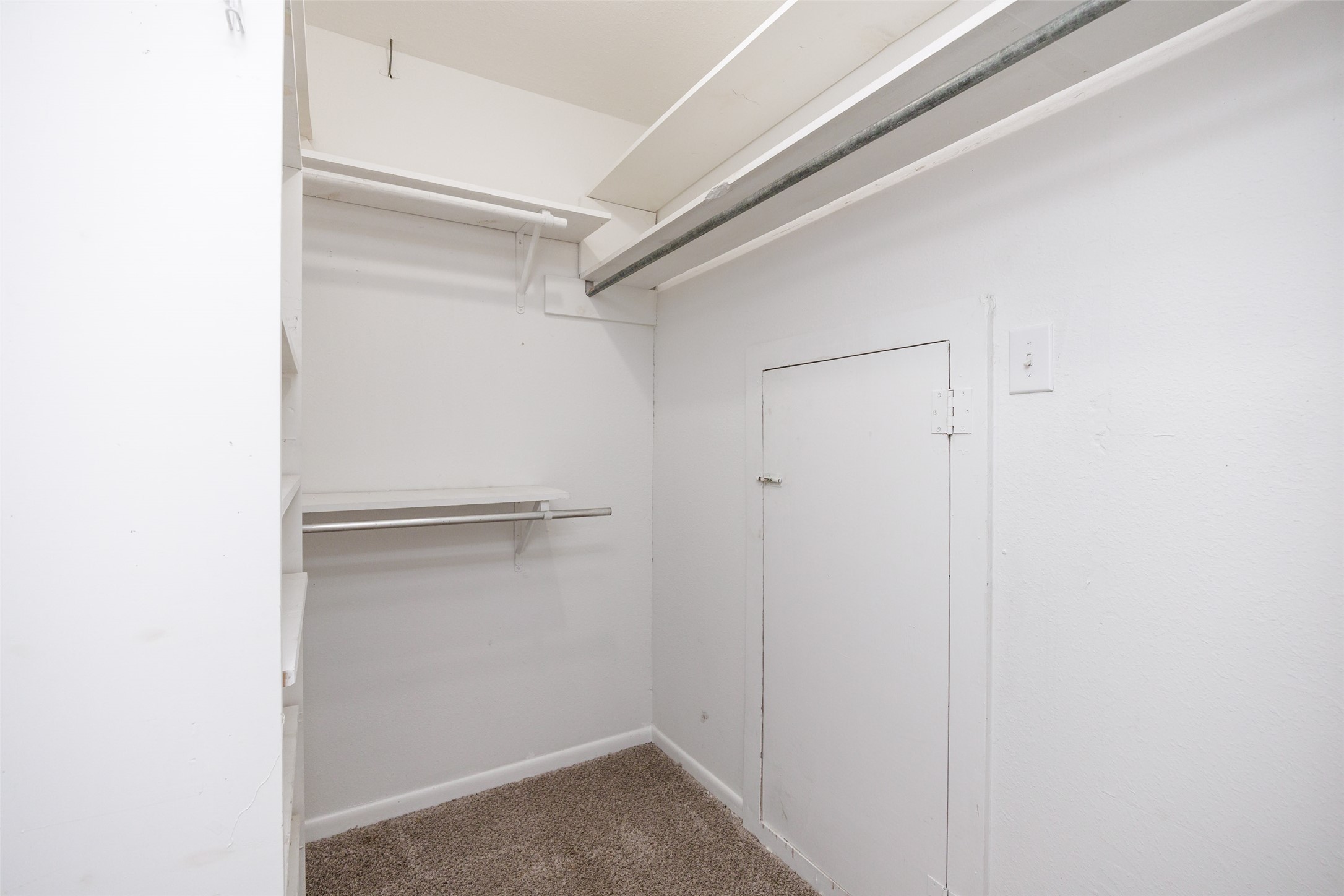 320 Long Point Drive Portland, TX 78374 - Photo 18 of 40 Walk-in closet featuring carpeted flooring, multiple shelving units, and a clothes hanging rod