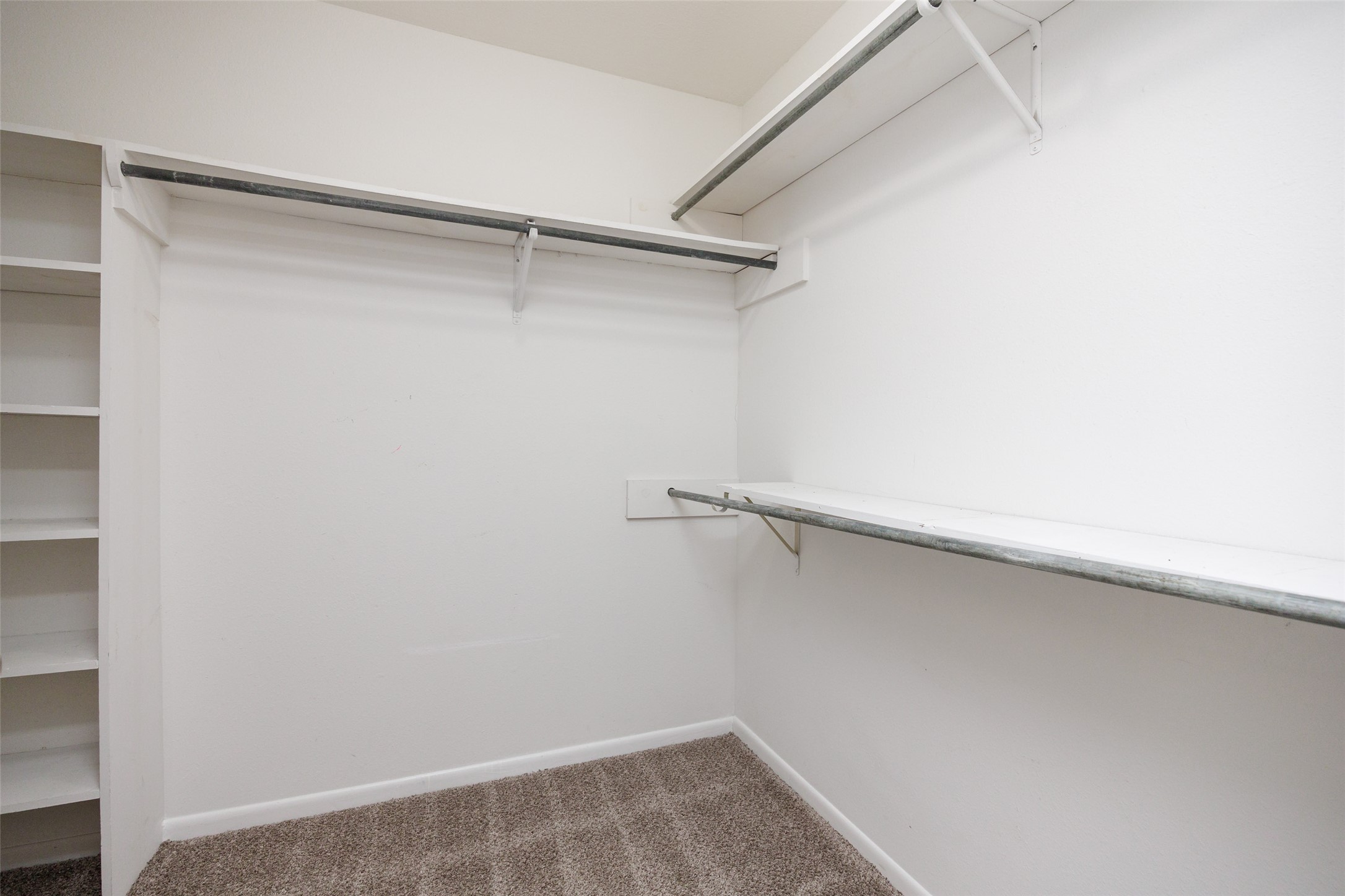 320 Long Point Drive Portland, TX 78374 - Photo 21 of 40 Walk-in closet featuring built-in shelving, white walls, and neutral-toned carpeting