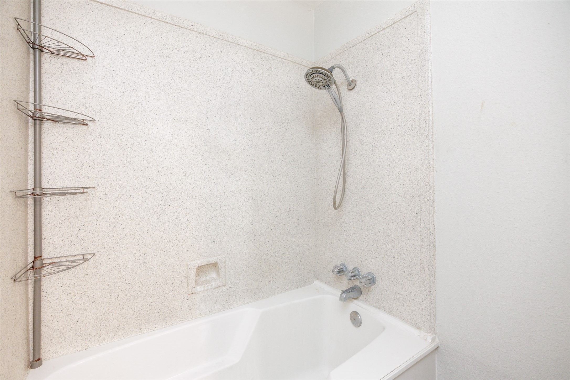 320 Long Point Drive Portland, TX 78374 - Photo 24 of 40 Tub and shower combination featuring a white speckled surround, chrome fixtures, and a handheld showerhead