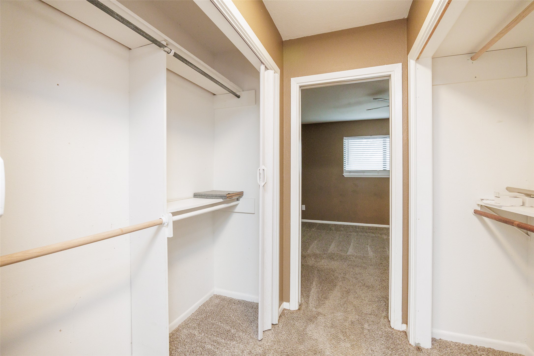 320 Long Point Drive Portland, TX 78374 - Photo 25 of 40 Twin closets with bi-fold doors, white shelving, and wood rods