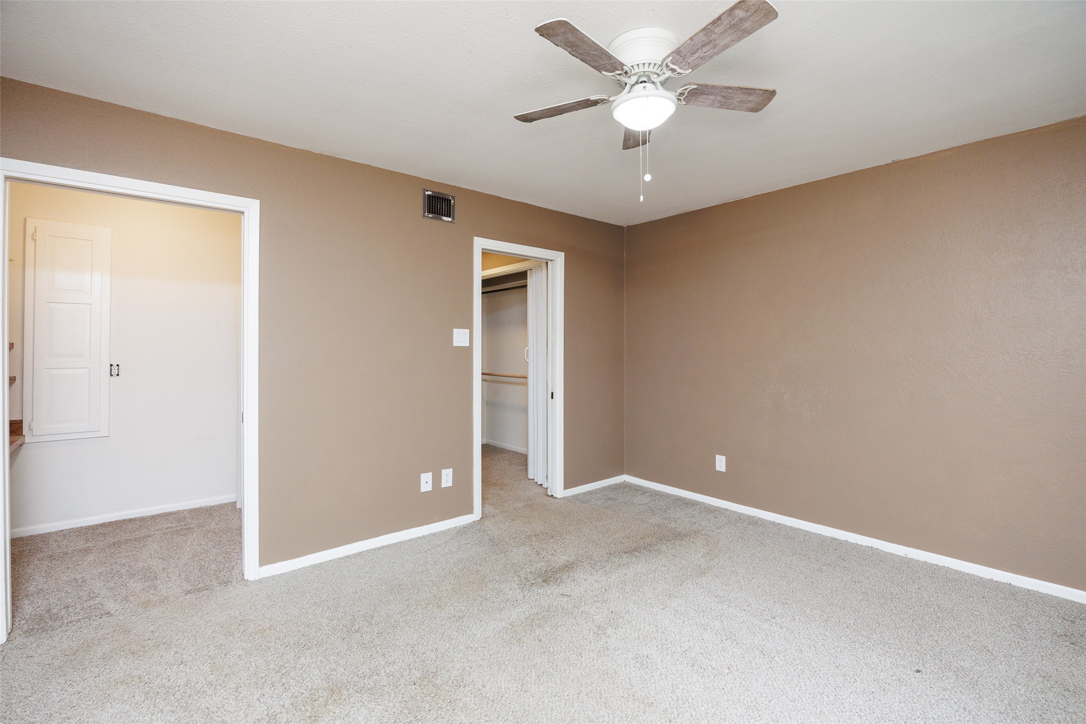 320 Long Point Drive Portland, TX 78374 - Photo 27 of 40 Spacious room featuring neutral carpeting, light brown wall tones, and a ceiling fan with integrated lighting