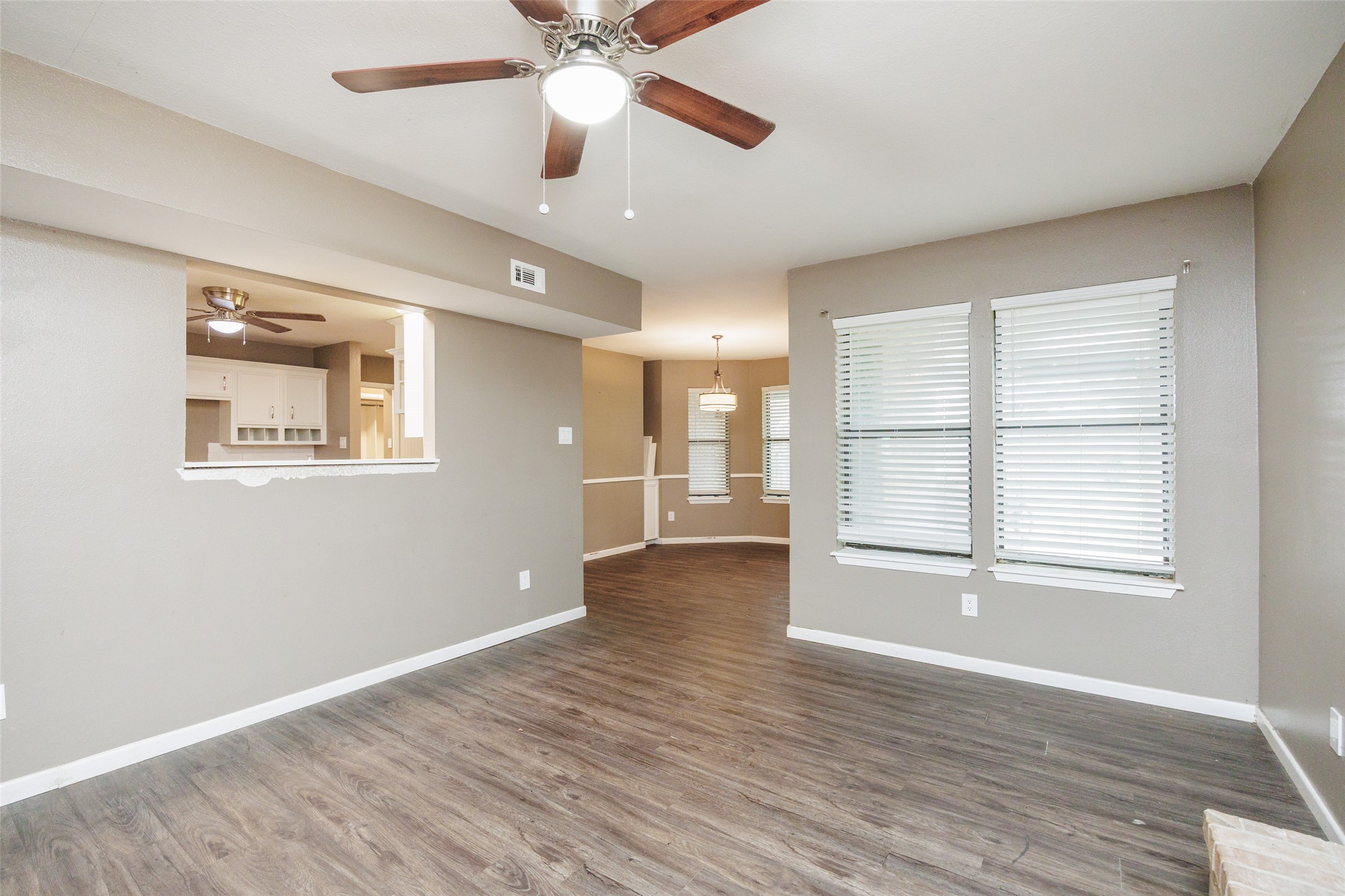 320 Long Point Drive Portland, TX 78374 - Photo 3 of 40 The living area offers an immediate sense of space from the foyer, featuring a convenient pass-through to the kitchen and large windows that draw in natural light from the backyard.