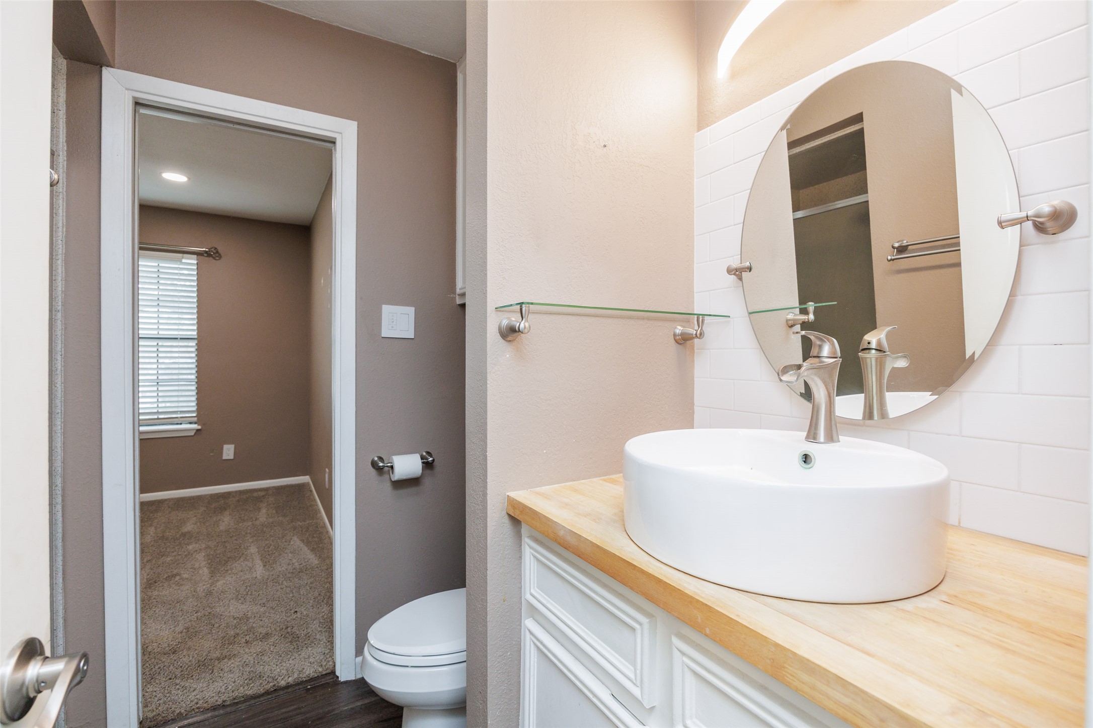 320 Long Point Drive Portland, TX 78374 - Photo 32 of 40 Bathroom vanity featuring a vessel sink, wood-finish countertop, and brushed nickel fixtures