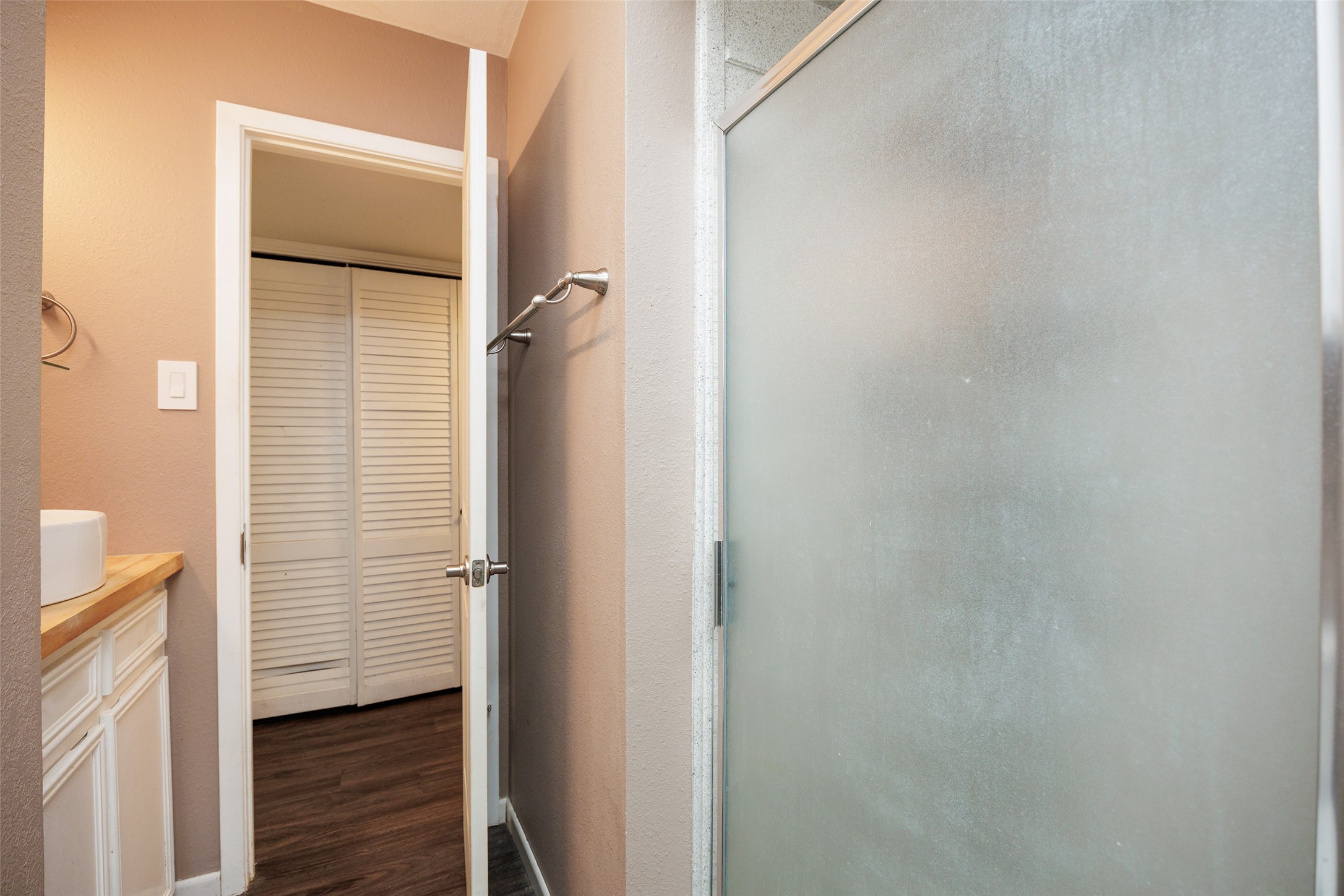 320 Long Point Drive Portland, TX 78374 - Photo 33 of 40 Frosted glass shower enclosure, white vanity with wood-finish countertop, and louvered bi-fold closet doors