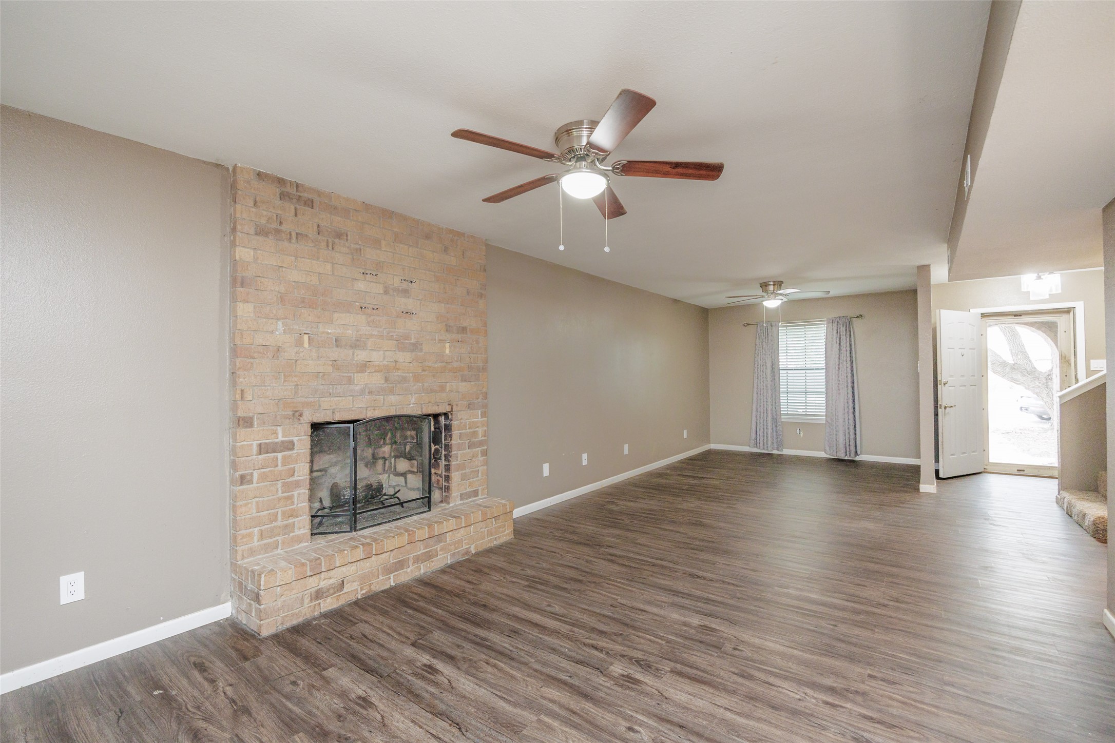 320 Long Point Drive Portland, TX 78374 - Photo 7 of 40 Large windows and a glass-paneled front door allow natural light to fill the living space, accentuating the clean lines and open feel of the main floor.
