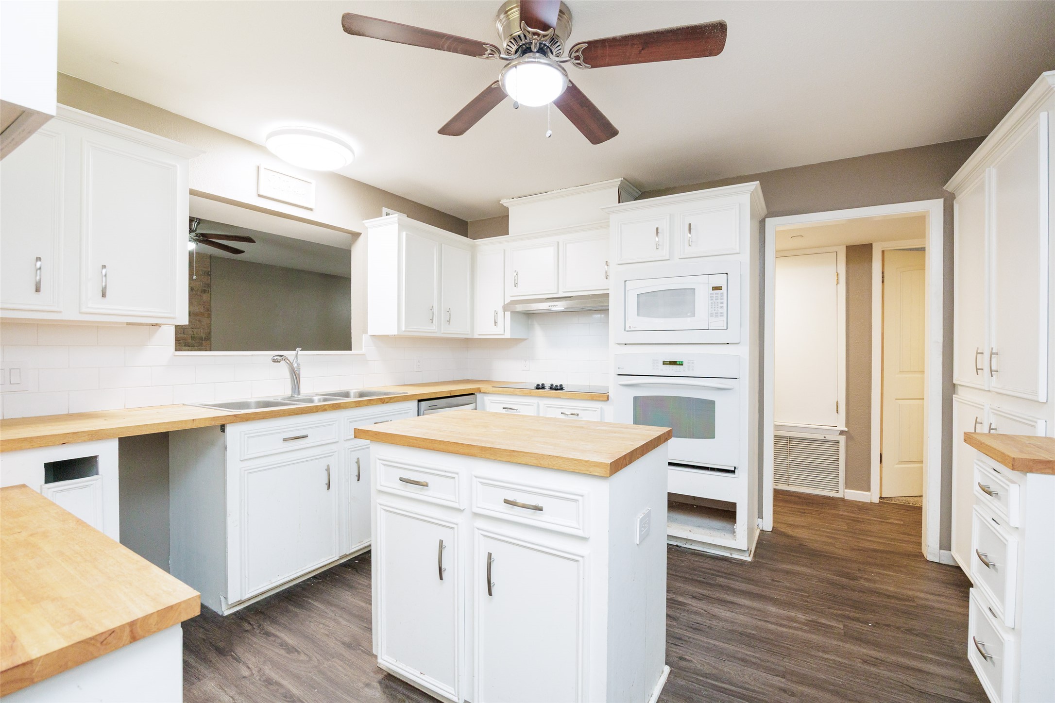 320 Long Point Drive Portland, TX 78374 - Photo 9 of 40 The functional kitchen centers around a convenient island and features crisp white cabinetry paired with warm, butcher-block style countertops.