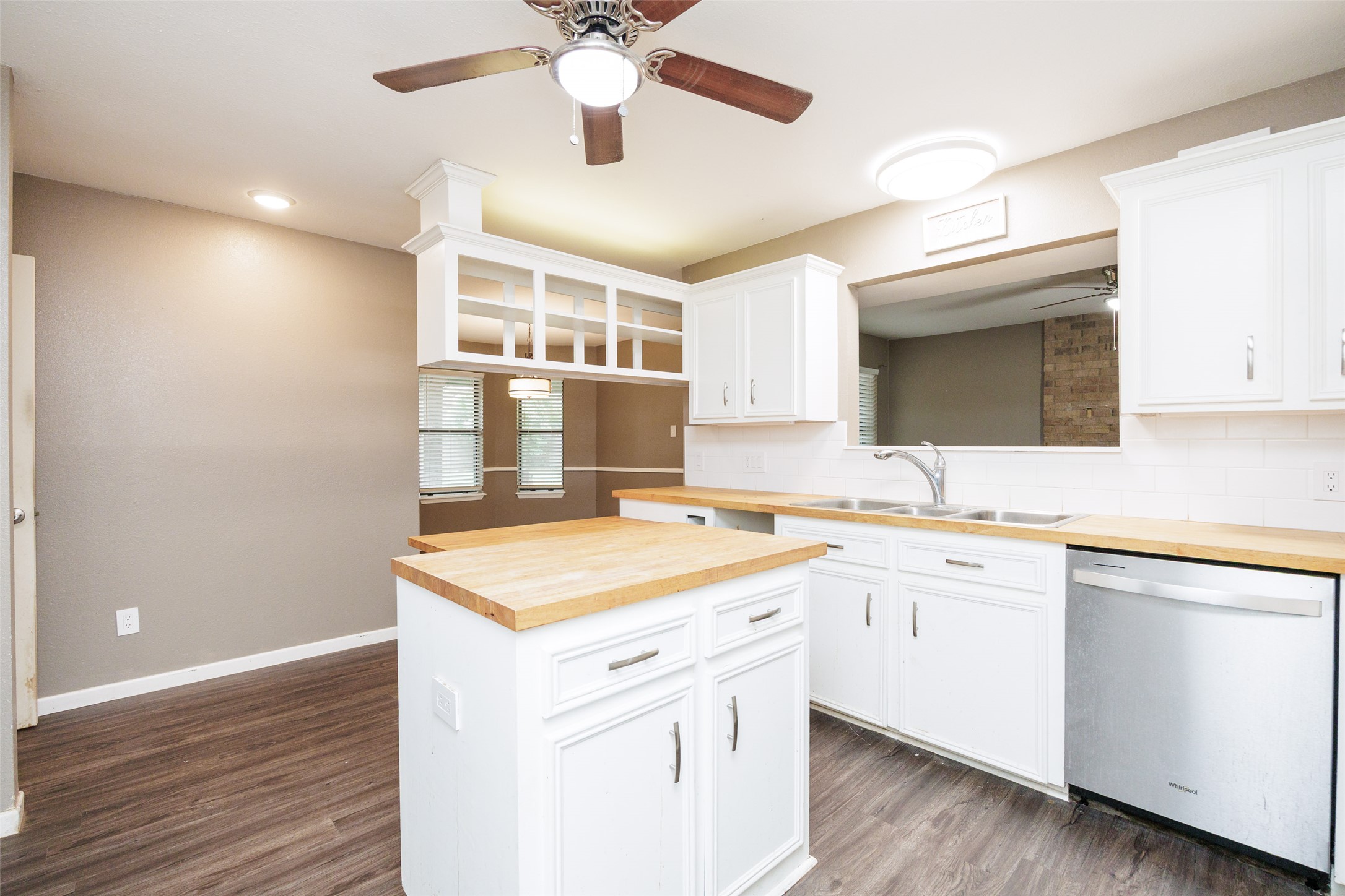 320 Long Point Drive Portland, TX 78374 - Photo 10 of 40 Enjoy a bright culinary space that offers ample prep surfaces and a clear line of sight into the dining area through the architectural cut-out.