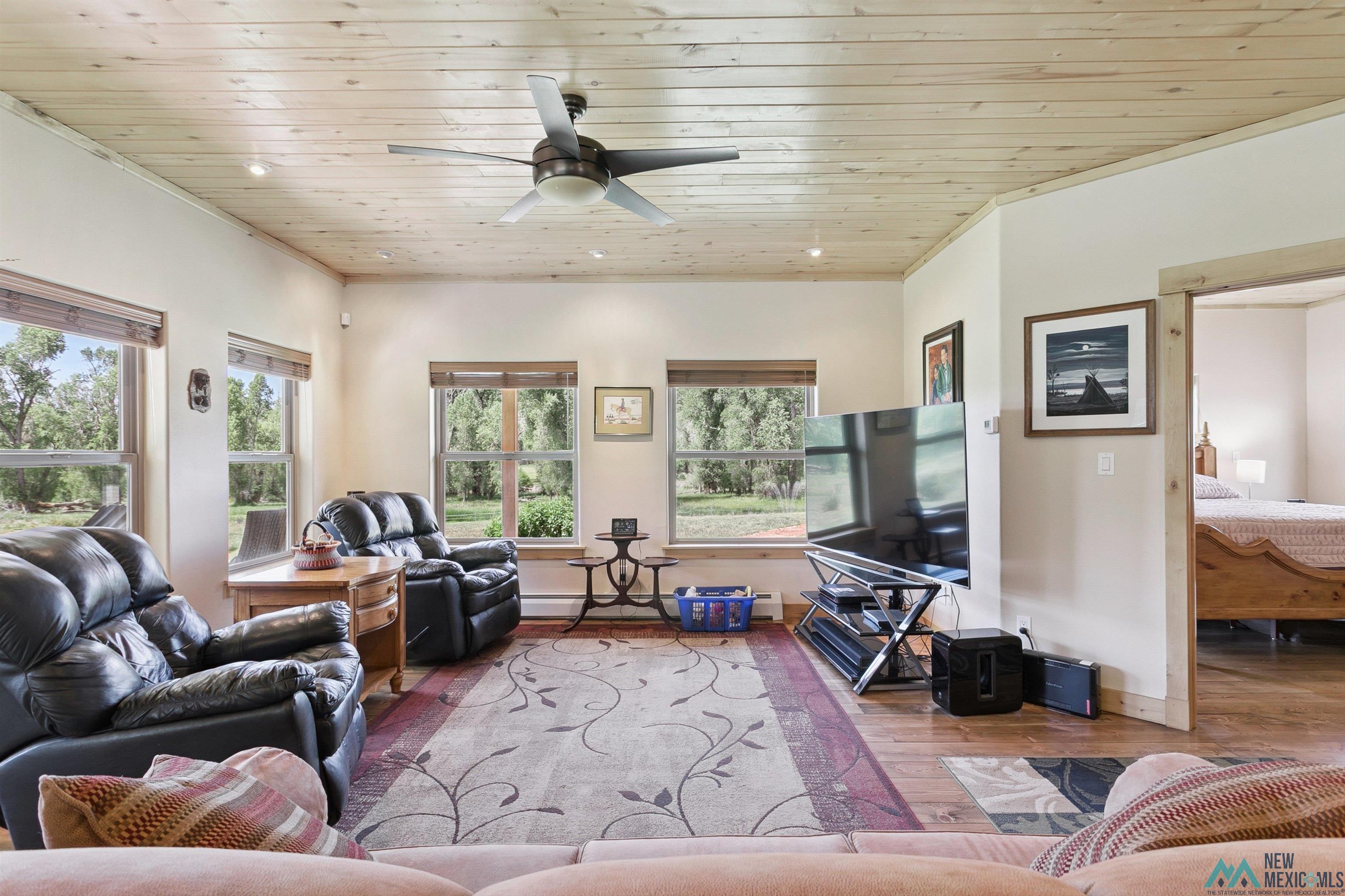 31 Cr 343 Road Chama, NM 87520 - Photo 9 of 44 Living area featuring wood ceiling, wood finished floors, healthy amount of natural light, recessed lighting, and ceiling fan