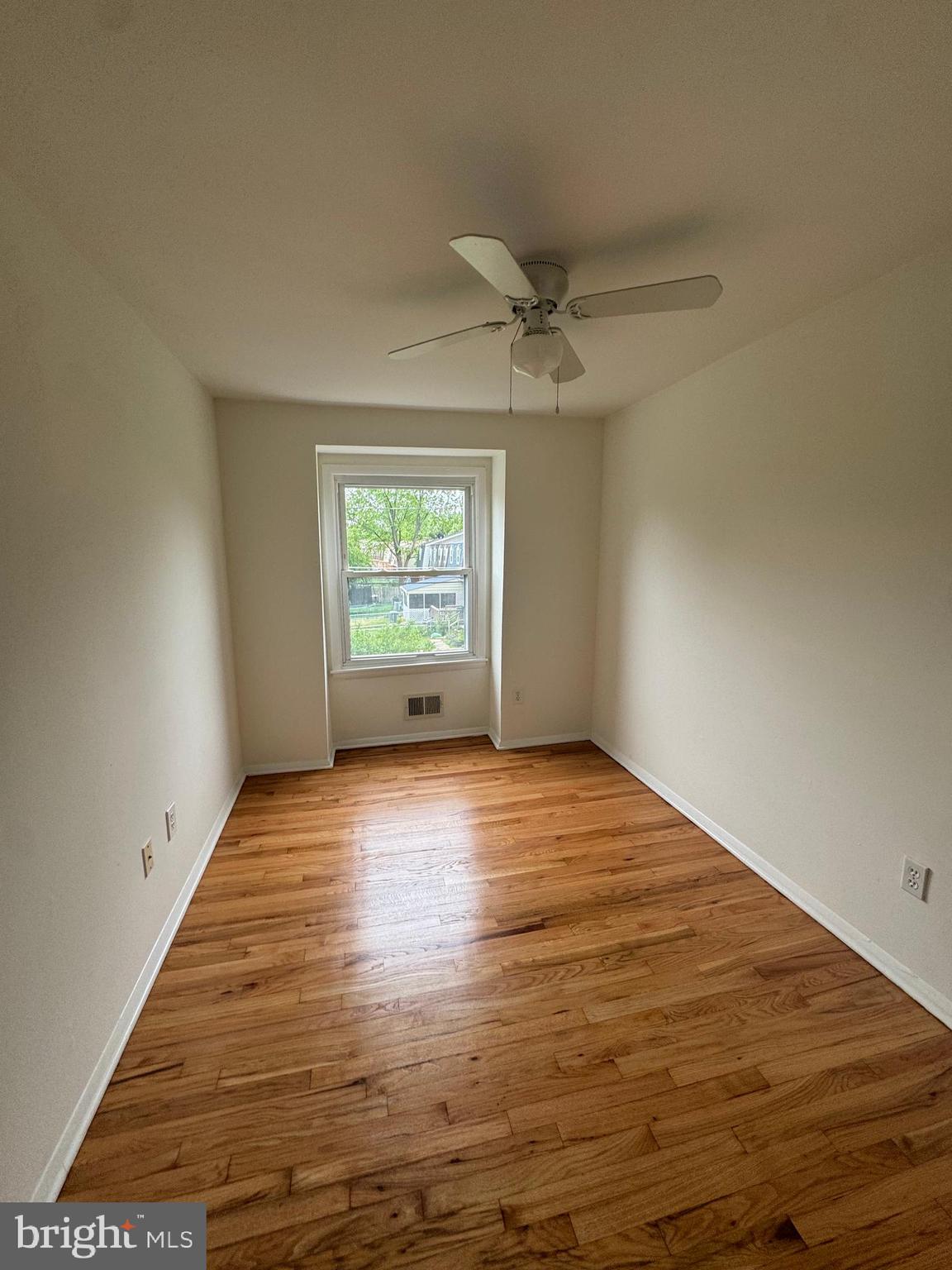 2128 Cockspur Road Middle River, MD 21220 - Photo 18 of 28 an empty room with wooden floor fan and windows