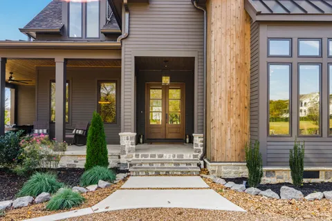 a dining hall with stainless steel appliances kitchen island granite countertop a table and chairs in it