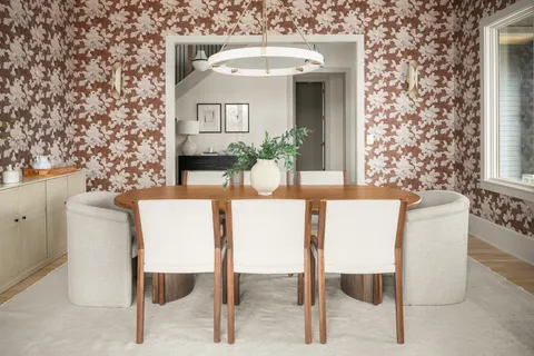 a kitchen with a dining table a sink cabinets and stainless steel appliances