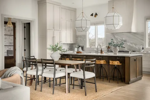 a kitchen that has a sink a stove and a table