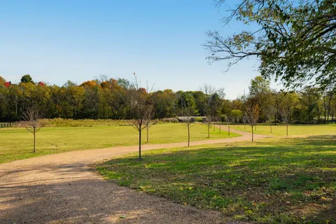 a living room with fireplace furniture and a large window