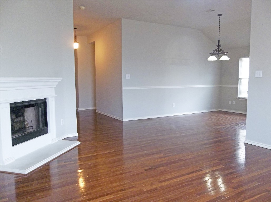 110 Fossil Trail Leander, TX 78641 - Photo 2 of 12 a view of empty room with wooden floor and fireplace