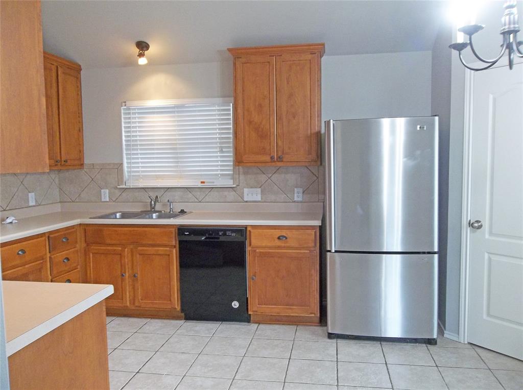 110 Fossil Trail Leander, TX 78641 - Photo 6 of 12 a kitchen with stainless steel appliances granite countertop a refrigerator and a sink