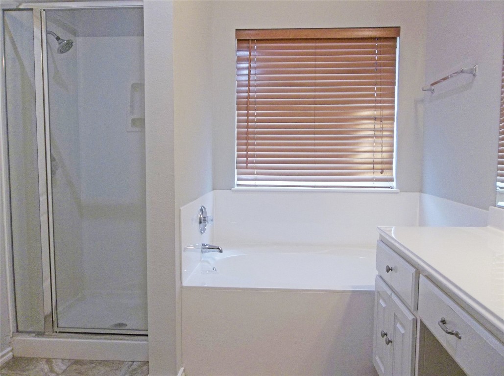110 Fossil Trail Leander, TX 78641 - Photo 9 of 12 a bath room with a sink and a bath tub