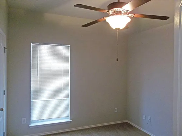 a small space with a window and a fan